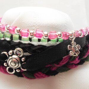 Handmade bracelet with rows of threads, beads, and charms No. 207